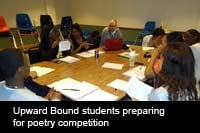 Upward Bound students sitting around a table, preparing for a poetry competition