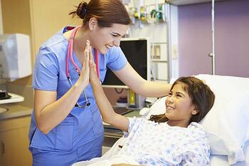 Nurse talking with hispanic child