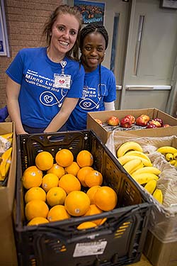 NMC nursing students with fruit available at the Minne Lusa Health Carnival.