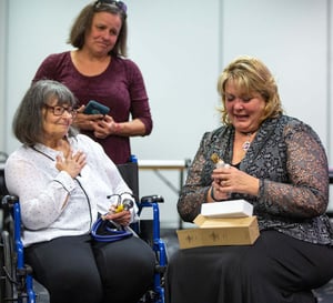 Jan Going and Stephanie Pettett exchange gifts as Shelly Going looks on.