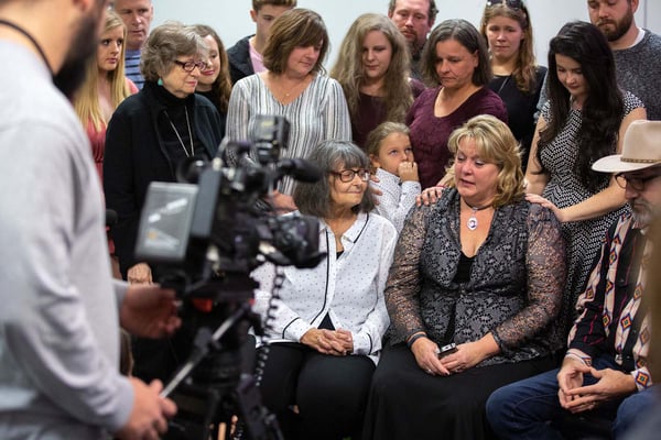 Media camera focuses on Jan Going and Stephanie Pettett as their families stand behind them.