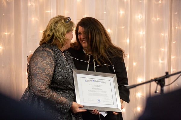 Stephanie Pettett, Michelle Massey hold Cheyla's honorary diploma.