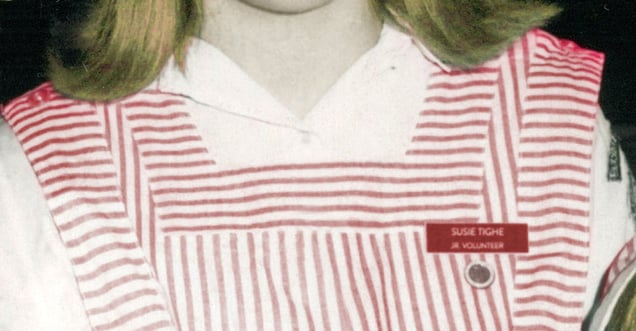 Photo illustration of red and white Candy Striper uniform with Susie's nametag and pin.