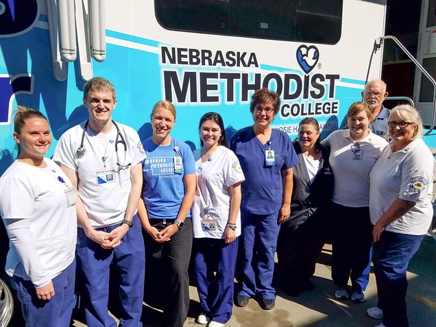 Nursing students and staff pose outside NMC's Mobile Diabetes Center.