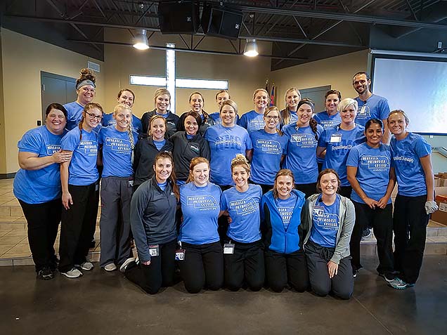 MOT Academic Fieldwork Coordinator Michelle Massey, MS, OTR/L (2nd row, far left), with MOT students. at the Foot Care Clinic for the Homeless.