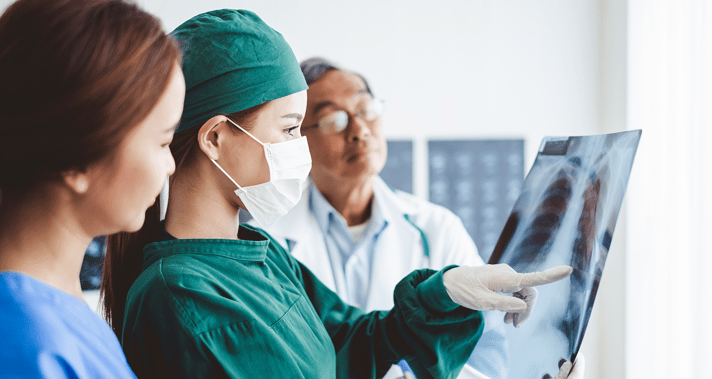 A Radiologic Technologist showing a patient their x-ray