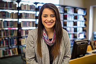 Abby standing in the NMC library