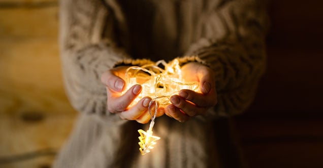 Holding Christmas lights in hands