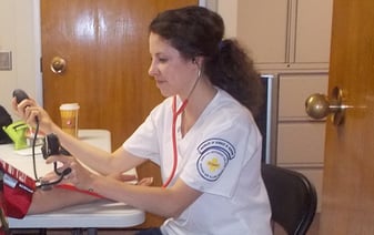 A nurse taking a man's blood pressure