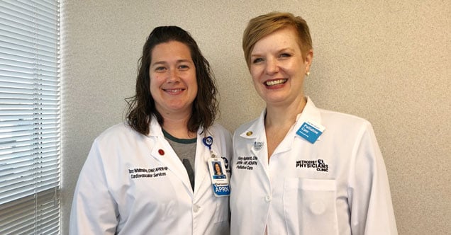 Dr. Tara Whitmire and Dr. Hilary Applequist standing next to each other in their lab coats. Dr. Tara Whitmire and Dr. Hilary Applequist are nurse practitioner educators in the BSN-DNP program at Nebraska Methodist College.