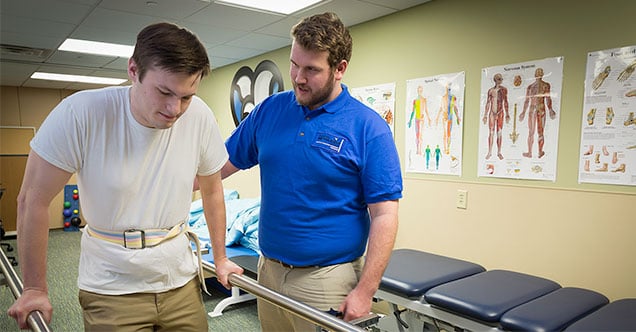 A physical therapist student practices hands-on at NMC’s PTA lab.