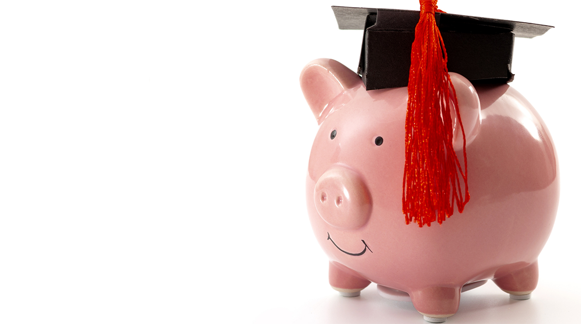 A piggy bank wearing a graduation cap with a red tassle.