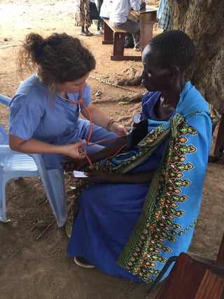 Nurse administrating a physical to a woman in South Sudan