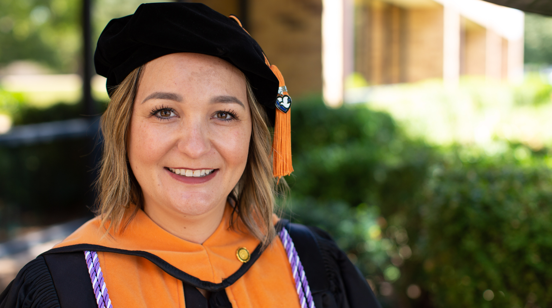 Nebraska Methodist College Doctor of Nursing Practice graduate Kelli Gunn wears her cap and gown after commencement.