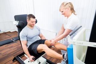 Physical Therapist Assistant Helping Athlete