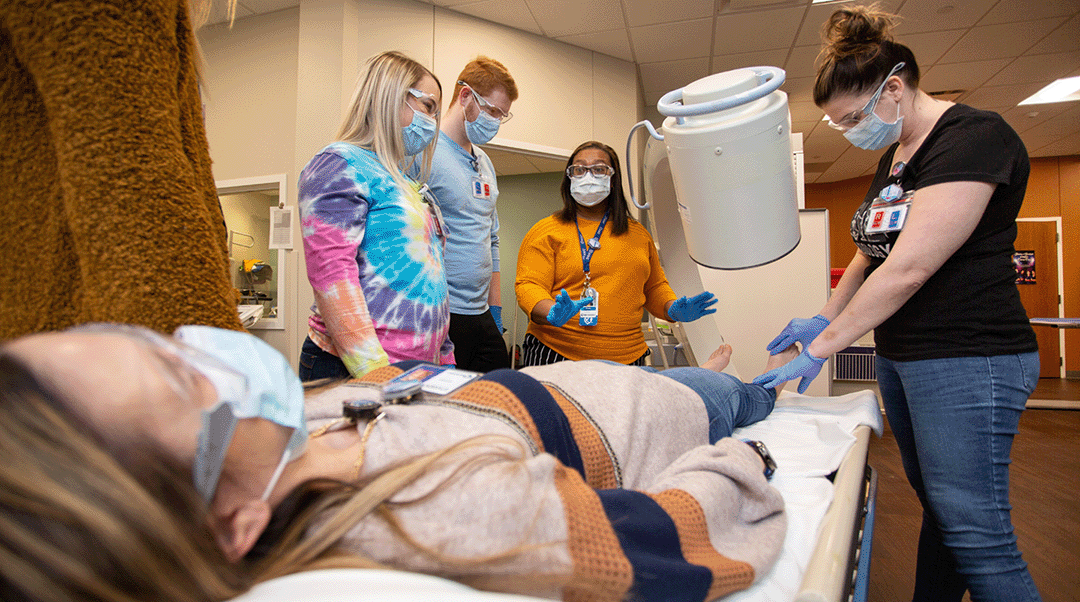 A Nebraska Methodist College faculty members teaches a group of students in the radiologic technology lab on campus.