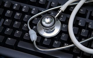 Stethoscope laying across a keyboard