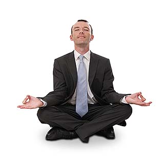 Man in a suit meditating as an example of office wellness