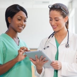 A nurse discussing a medical chart with another nurse