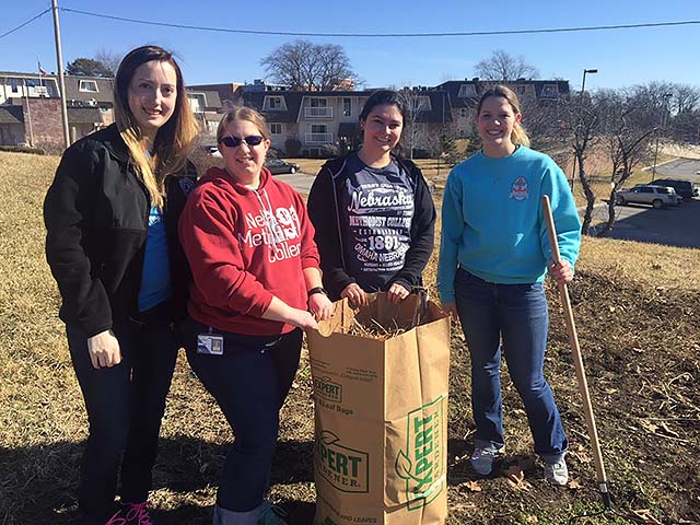 Three of the students who worked on the NMC Community Garden this week to preparing the ground for spring planting. 