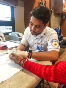 NMC nursing student Angelo Andal provides a diabetes screen.