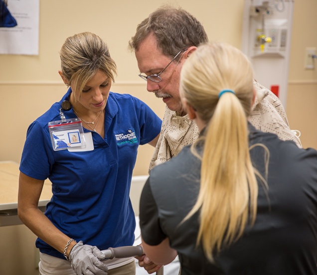 Nebraska Methodist College student in the Master of Occupational Therapy program helping a patient with daily living skills. 