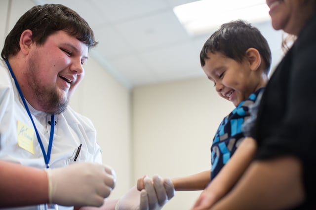 Pediatric nurse Matthew Kisicki, a recent Nebraska Methodist College graduate, shown volunteering his time to do lead testing in the schools.