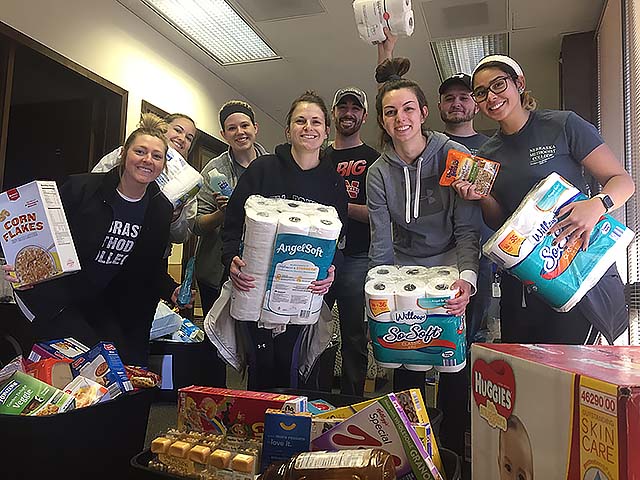 Nursing students moving food and toiletries to a new, larger location for the Nebraska Methodist College's Food Pantry, stocked with non-perishable grocery items for students in need.