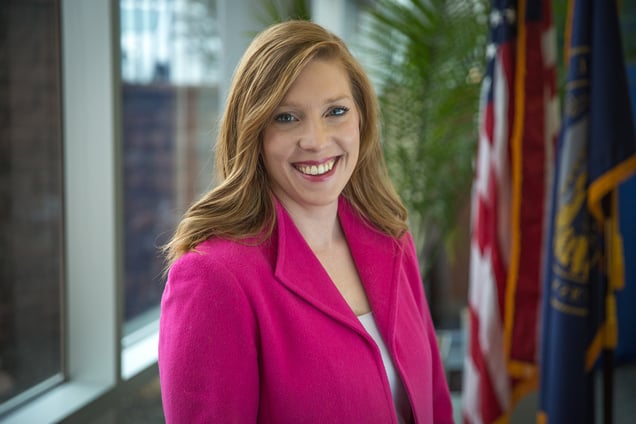 photo of NMC alum Anne Boatright beside U.S. and Nebraska flags.