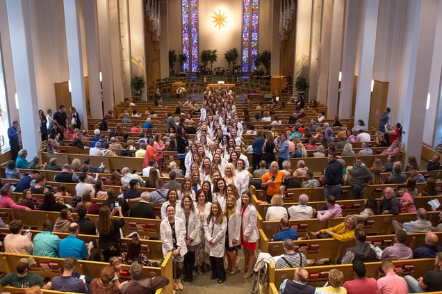 Ninety NMC nursing students line the aisle of First United Methodist Church just prior to the Edna A. Fagan Pledging Ceremony on April 13. 
