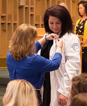 An NMC student nurse is pinned at the 2018 pledging ceremony. 