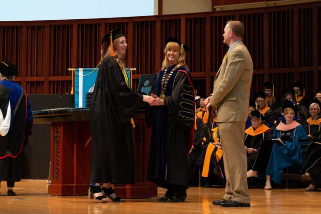 NMC President & CEO Deb Carlson congratulates a new graduate.