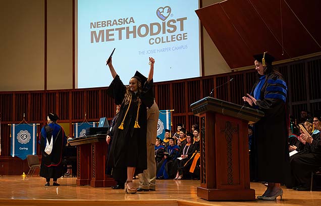 A joyful moment onstage after a student  receives her diploma.