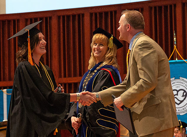 Christa Reisdorff receives her diploma at NMC's Spring 2018 Commencement.