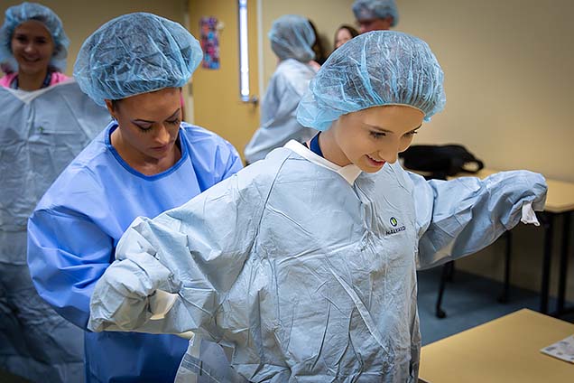 Lyndsay H., a Methodist Hospital volunteen, shown participating in the surgical technology class at NMC’s Summer High School Healthcare Career Camp.