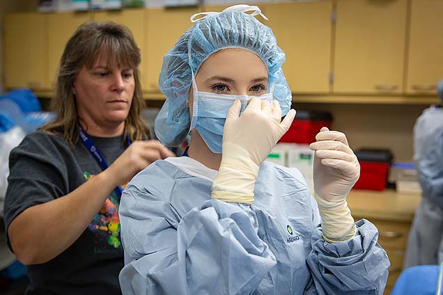 Lyndsay H., a Methodist Hospital volunteen, shown participating in the surgical technology class at NMC’s Summer High School Healthcare Career Camp.
