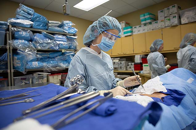 Lyndsay H., a Methodist Hospital volunteen, shown participating in the surgical technology class at NMC’s Summer High School Healthcare Career Camp.