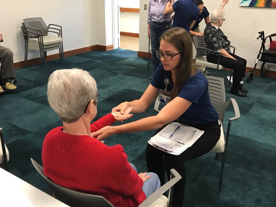 Masters of Occupational Therapy student practicing her occupational skills on a volunteer