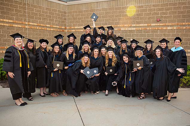 First class to graduate from Nebraska Methodist College Master of Occupational Therapy (MOT) program, in caps and gowns after August 3 commencement ceremony.