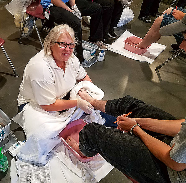 Lisa Kessler provides foot care at the Open Door Mission.