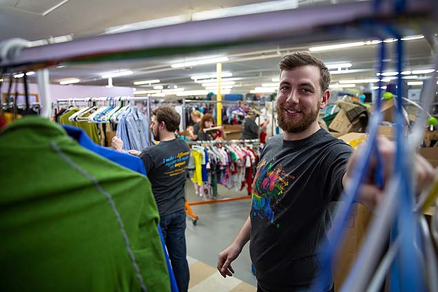 NMC faculty and staff sorting and organized clothing at the Open Door Mission Timberlake Outreach Center.