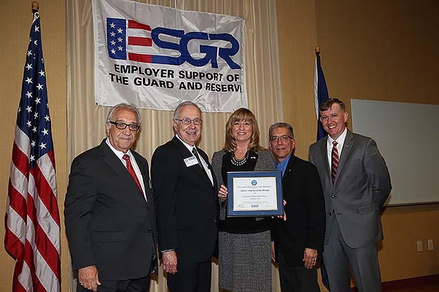 Representative from Nebraska Methodist College being presented the Above and Beyond Award at the Nebraska Committee for Employer Support of the Guard and Reserve (ESGR) in 2017