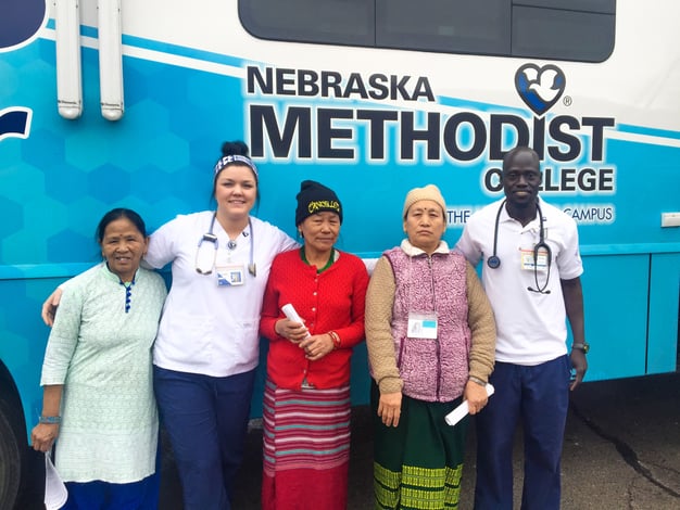 Image of Nebraska Methodist College nursing students and natives of Nepal outside NMC's Mobile Diabetes Center. As part of the college's community-based nursing and allied health curriculum, NMC nursing students and faculty provided diabetes screenings for elderly immigrants and refugees at Omaha's Intercultural Senior Center.