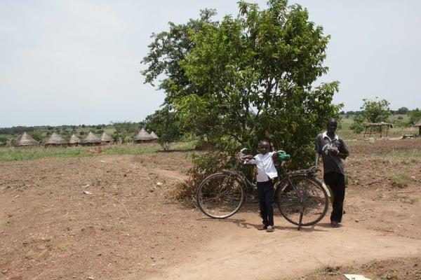 Anna was 13 years old when she left Sudan. In the background of this photo is her village.