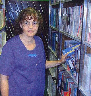 In this historic photo, Nebraska Methodist College Library Assistant Tem Adair checks the stacks.