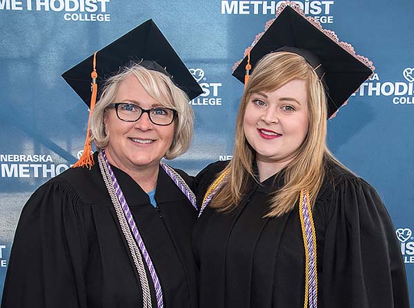 Closeup of Lisa & Cassandra Kessler in graduation caps and gowns