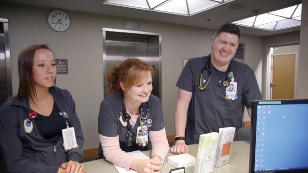 Three nurses congregated at the nurses' station. Blake Smith was willing to change his course so that he could fulfill his goal to be a healthcare practitioner.
