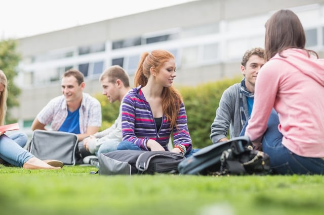 Freshmen Nebraska Methodist College students sitting outside in the yard, chatting and studying