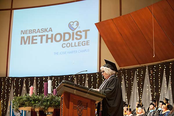 Lisa Kessler at podium, giving commencement speech.