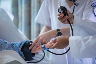 A Nursing student taking a child's blood pressure as a part of their nursing education with no prerequisites